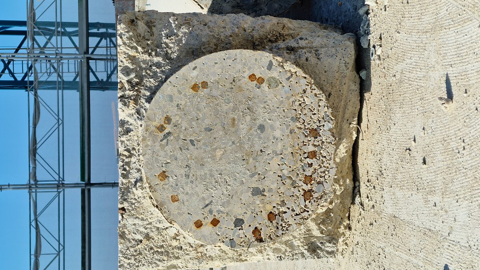 A cut column end exposes the concrete cross-section.