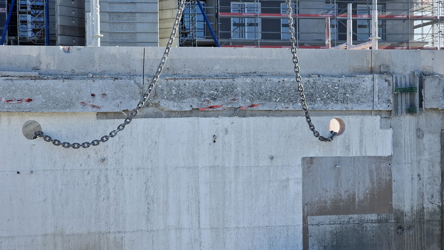 Lifting chains attached through prepared openings in the concrete.